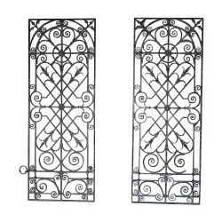 Pair of wrought iron door grilles, richly …